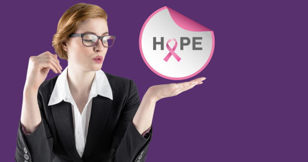 Image of hope text with pink ribbon over young woman. breast cancer positive awareness campaign concept digitally generated image.の写真素材
