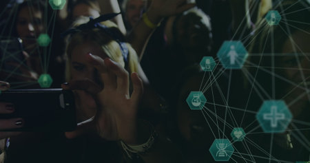 Image of connections of hexagons with icons over hands of diverse people on concert. music, entertainment, fun and connections concept digitally generated image.の写真素材