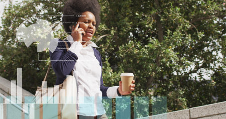 Image of data processing over african american businesswoman walking. Global business and digital interface concept digitally generated image.の写真素材