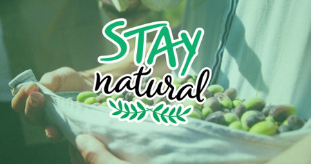 Image of stay natural text over caucasian man picking fruit. Global ecology, organic and digital interface concept digitally generated image.の写真素材