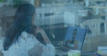 Image of digital interface over biracial people using laptop. Global connections, data processing and digital interface concept digitally generated image.の写真素材