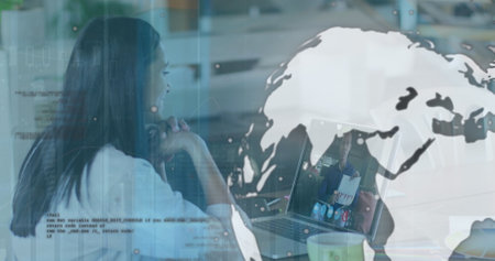Image of data processing and globe over biracial woman using laptop. Global business and digital interface concept digitally generated image.の写真素材