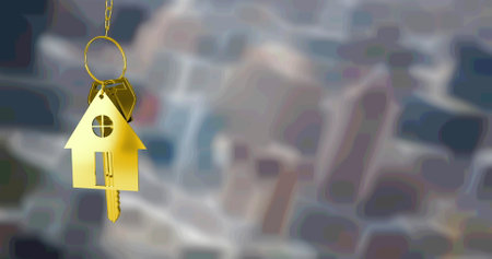 Image of gold house key fob and key, hanging in front of blurred city buildings. property business, home and finance concept digitally generated image.の写真素材