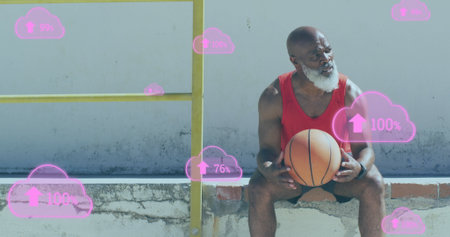 Image of clouds with percentage over senior african american man with basketball at beach. healthy, active lifestyle, connections and digital interface concept digitally generated image.の写真素材