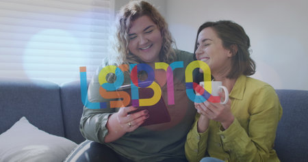 Image of lgbtq over happy caucasian lesbian couple using tablet and sitting on sofa at home. supporting lgbt rights and gender equality digitally generated image.の写真素材