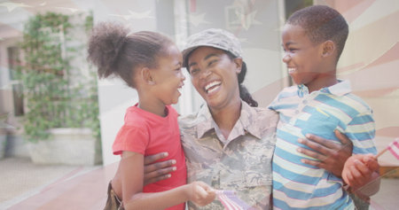 Image of flag of usa over african american female soldier with her children. Patriotism and celebration concept digitally generated image.の写真素材