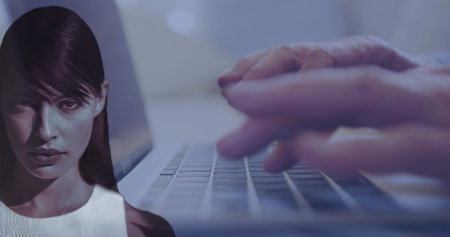 Image of data processing over caucasian woman and hands using laptop. Global business and digital interface concept digitally generated image.の写真素材