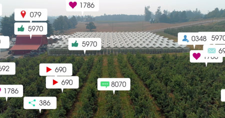 Image of social media icons floating against aerial view of solar panels in grassland. Social media networking and renewable energy conceptの写真素材