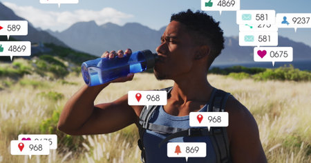 Image of notification bars over biracial man drinking water against mountain and cloudy sky. Digital composite, multiple exposure, business, hiking, social media reminder and technology concept.の写真素材