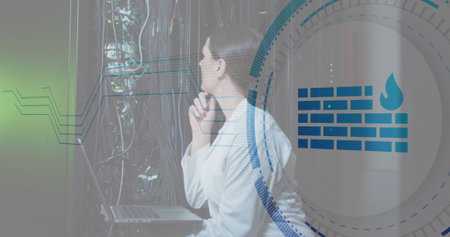 Image of firewall icon over caucasian female engineer checking data server using laptop. Digital...