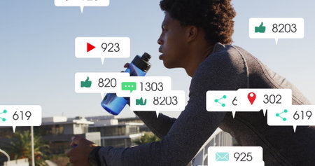 Image of changing numbers, icons in notification bars, african american athlete drinking water....