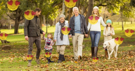 Caucasian family walking in park, including five members and dog. Enjoying a sunny day outdoors,...