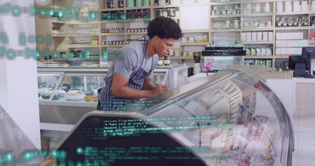 Image of financial data processing with red lines over man working in shop. Global business, finance, computing and data processing concept digitally generated image.の写真素材