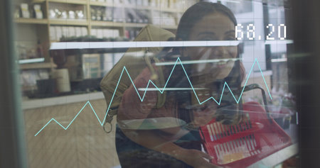 Image of financial data processing over woman shopping. Global business, finance, computing and data processing concept digitally generated image.の写真素材