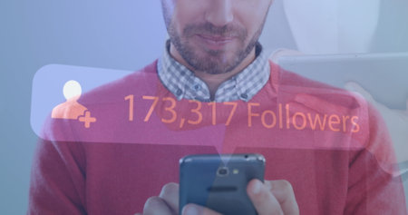 Image of increasing followers against mid section of caucasian smiling while using smartphone. Social media networking and business technology conceptの写真素材