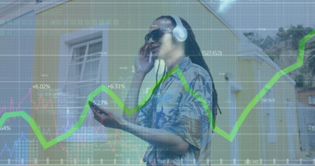 Image of data processing over biracial man using smartphone. Global business, computing, digital...