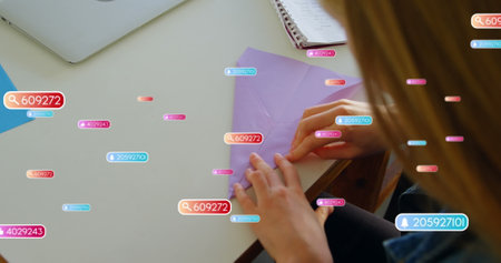 Image of notification bars, overhead view of caucasian girl folding craft paper. Digital composite,...