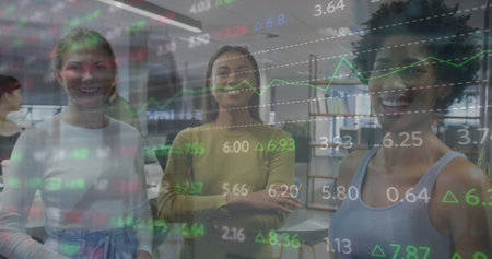 Image of stock market data processing against portrait of three diverse women smiling at office. Global economy and business technology conceptの写真素材