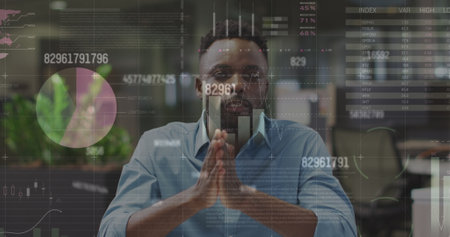 Image of data processing over african american man talking looking at the camera at office. Computer interface and business data technology conceptの写真素材