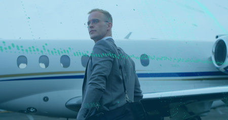 Image of graph and changing numbers over caucasian man with bag walking towards airplane. Digital...