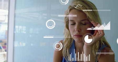 Image of graphs, loading circles, bars, caucasian woman having headache while working on laptop. Digital composite, multiple exposure, report, business, progress and technology concept.の写真素材