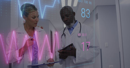 Image of heart rate monitor against diverse male and female doctors discussing at hospital. Medical...