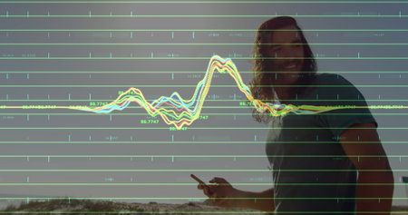 Image of financial data processing over cuaciasn couple in summer using smartphone. Global business, finances, computing and data processing concept digitally generated image.の写真素材