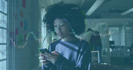 Image of financial data processing against african american woman using smartphone at office. Global...