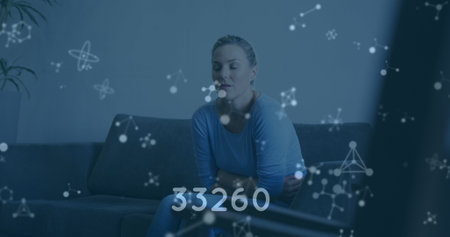 Image of medical data processing over caucasian woman on couch. global medicine and digital...