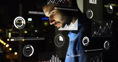 Image of infographic interface over caucasian businessman working in office at night. digital composite, business, report, progress, technology, focus, working late concept.の写真素材