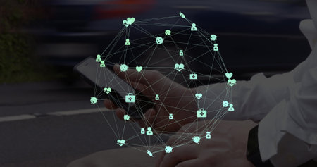 Globe of digital icons spinning against mid section of a man using smartphone on the street. Social media networking and technology conceptの写真素材