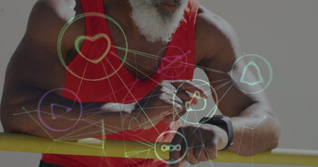 Image of network of connections over senior african american man using smartwatch at beach. healthy, active lifestyle, connections and digital interface concept digitally generated image.の写真素材
