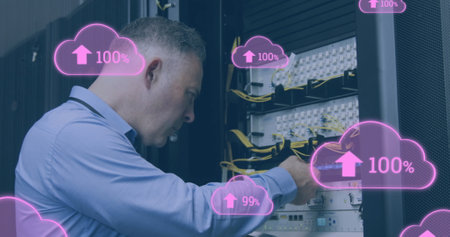 Image of clouds with increasing numbers over caucasian man working in server room. cloud computing,...