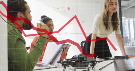 Image of statistical data processing against team of diverse colleagues discussing at office. Computer interface and business data technology conceptの写真素材