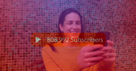Image of subscribers text with growing number over caucasian woman using smartphone. Social media,...