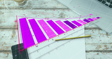 Image of arrow on graph over coffee cup, cellphone and laptop on wooden table. Digital composite, multiple exposure, report, business, beverage, drink and technology concept.の写真素材