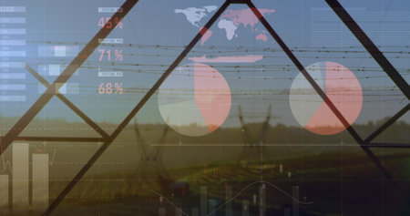 Image of financial graphs and data over electricity poles at sunset. Energy, electricity, finance and economy concept digitally generated image.の写真素材