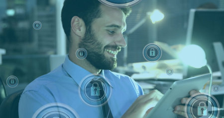 Image of padlock in circles over caucasian man scrolling on smartphone in office. Digital composite, multiple exposure, protection, security, encryption and technology concept.の写真素材