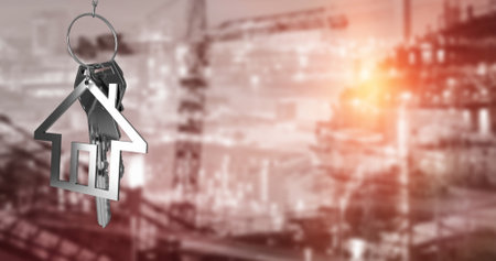 Image of silver house key and fob over out of focus cityscape. Global business, finances, computing and data processing concept digitally generated image.の写真素材