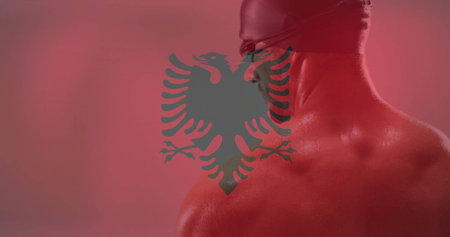 Image of flag of albania over caucasian male athlete. Global sports, competition and patriotism concept digitally generated image.の写真素材