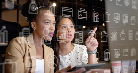 Image of currency and data processing over diverse businesswomen in office. Global finance, business, connections, computing and data processing concept digitally generated image.の写真素材