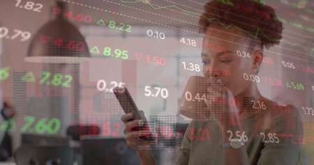 Image of financial data processing over african american businesswoman in office. Global finance, business, connections, computing and data processing concept digitally generated image.の写真素材