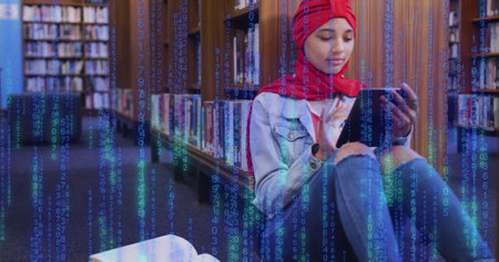 Image of ai text and data over biracial female student in hijab with tablet. Global artificial intelligence, connections, computing and data processing concept digitally generated image.の写真素材