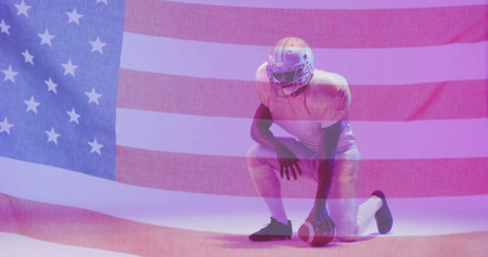 Image of african american american football player kneeling with ball and flag of usa. American...
