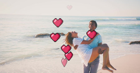 Image of hearts moving over biracial man carrying woman on beach in summer. Love, romance, valentine's day and vacation concept digitally generated image.の写真素材