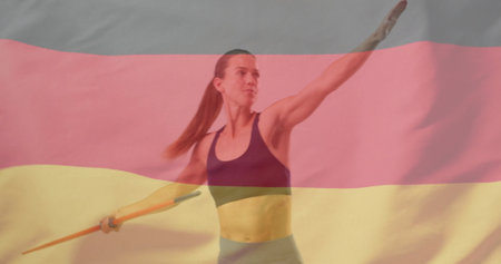 Image of flag of germany over caucasian female javelin thrower. Global sports, competition and patriotism concept digitally generated image.の写真素材