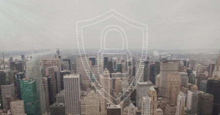 Image of padlock and shield icon over modern cityscape. Network, data, security, digital interface, connection, business and communication, digitally generated image.の写真素材