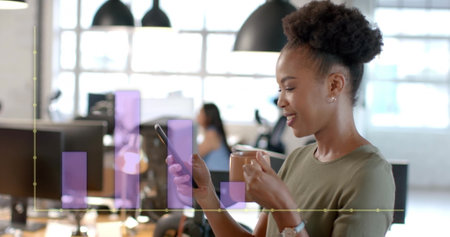 Image of financial data processing over african american businesswoman in office. Global finance, business, connections, computing and data processing concept digitally generated image.の写真素材