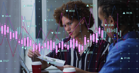 Image of graph processing data over diverse male colleagues talking at casual office. Business, connection, teamwork, digital interface and communication, digitally generated image.の写真素材