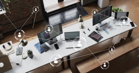 Image of digital icons with connections over computers on desks in office. Global finance, business, connections, computing and data processing concept digitally generated image.の写真素材
